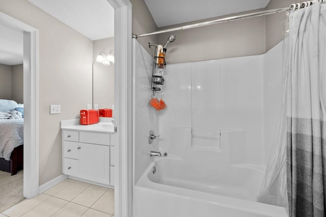 full bathroom featuring tile patterned floors, baseboards, vanity, shower / tub combo with curtain, and ensuite bath