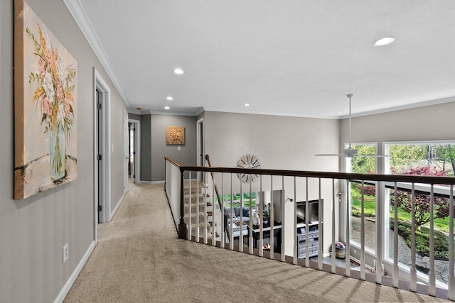 corridor featuring carpet flooring, recessed lighting, crown molding, and baseboards