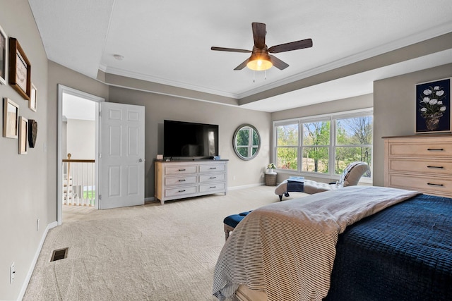 carpeted bedroom featuring crown molding, baseboards, a ceiling fan, and visible vents