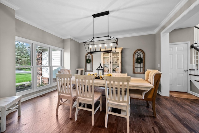dining area with an inviting chandelier, crown molding, dark wood-style floors, and visible vents