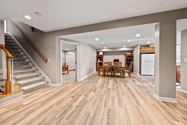 dining space featuring stairway, baseboards, light wood-style floors, and recessed lighting