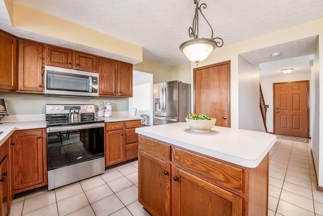 kitchen featuring stainless steel appliances, brown cabinets, and light countertops