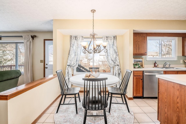 dining area featuring a textured ceiling, baseboards, and light tile patterned floors