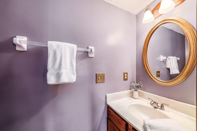 bathroom with vanity and a textured ceiling