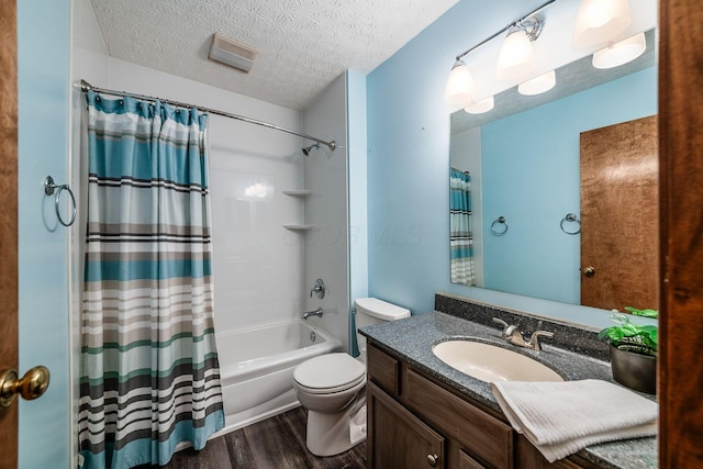 bathroom featuring a textured ceiling, toilet, wood finished floors, vanity, and shower / bathtub combination with curtain