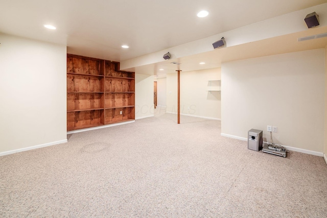 finished basement featuring built in features, baseboards, carpet flooring, and recessed lighting