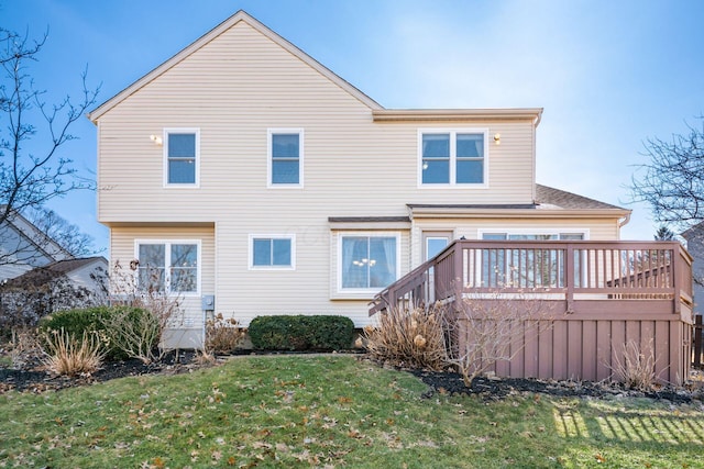 rear view of property with a lawn and a wooden deck