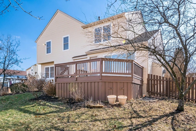 back of house with a lawn, fence, and a wooden deck