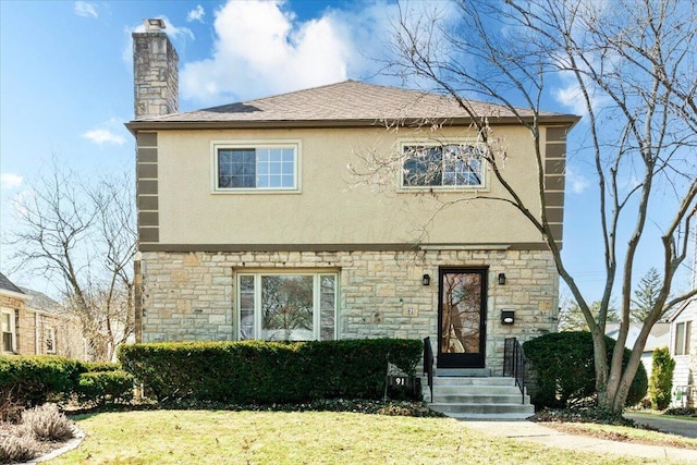 view of front of property with stone siding, stucco siding, a chimney, and a front yard