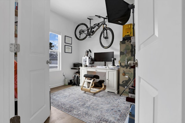 office area featuring light wood-style floors and baseboards