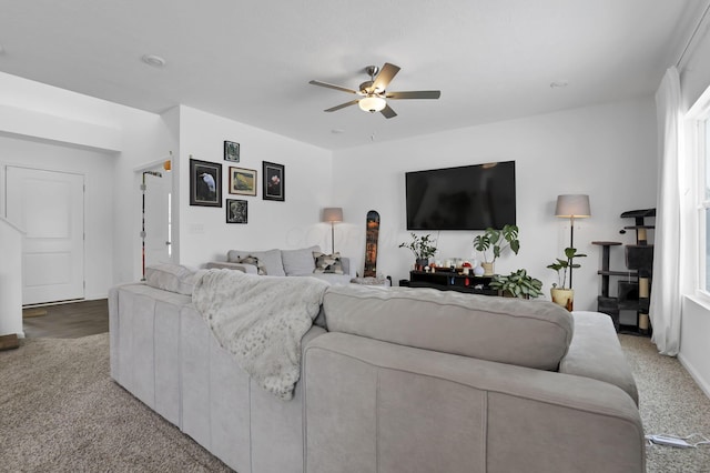 carpeted living room with a ceiling fan