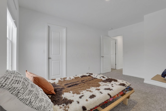 bedroom with carpet and baseboards