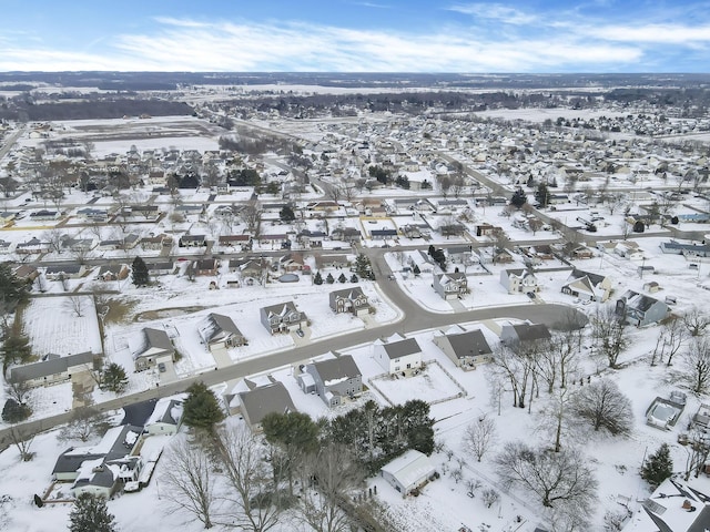 snowy aerial view featuring a residential view