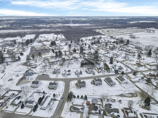 snowy aerial view featuring a residential view