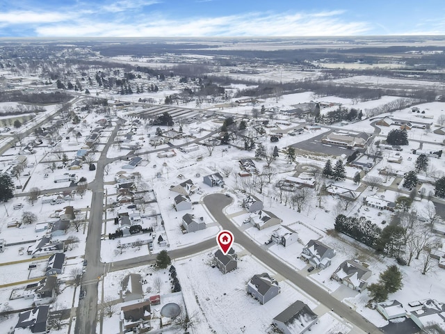 snowy aerial view with a residential view