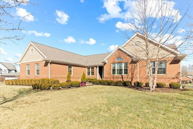 single story home featuring brick siding and a front yard