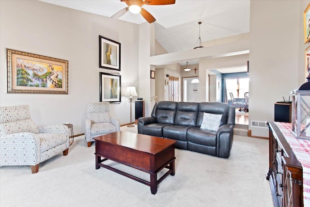 living room featuring baseboards, visible vents, a ceiling fan, light colored carpet, and high vaulted ceiling