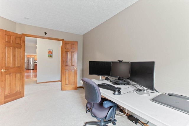 office featuring light carpet, vaulted ceiling, a textured ceiling, and baseboards