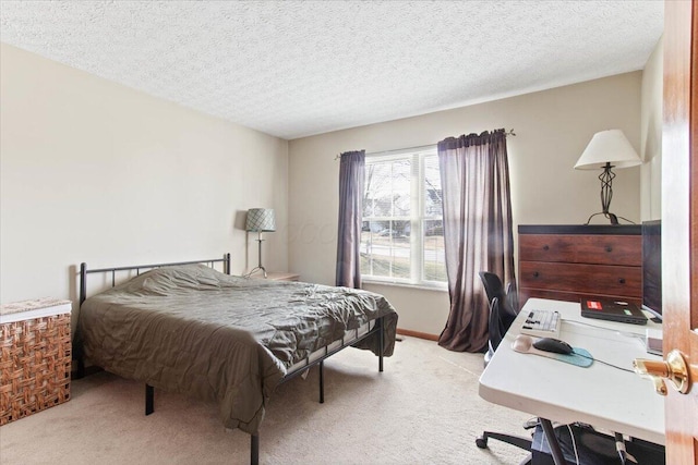 bedroom featuring light carpet and a textured ceiling