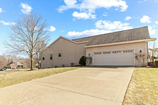 view of front of home featuring concrete driveway, a front lawn, an attached garage, and stucco siding