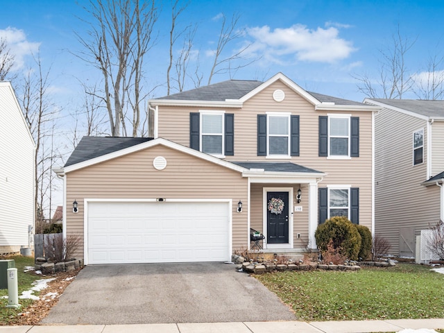 view of front of home featuring aphalt driveway, a front lawn, and an attached garage