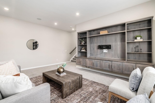 living room with stairs, recessed lighting, dark carpet, and baseboards