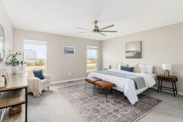 bedroom featuring a ceiling fan, carpet flooring, visible vents, and baseboards