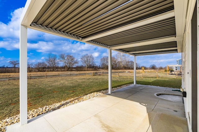 view of patio with a rural view and fence