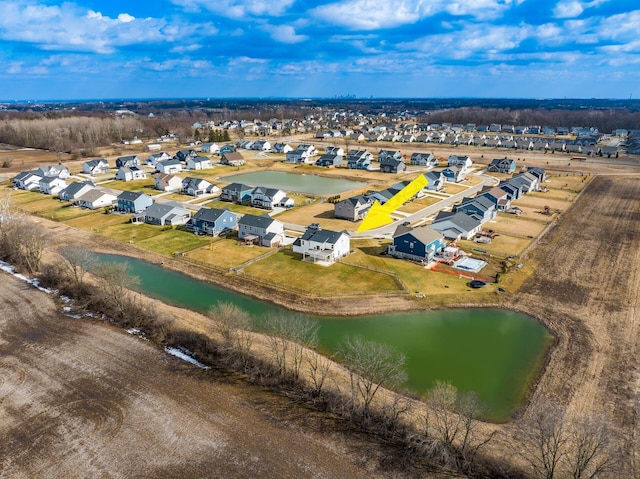 birds eye view of property with a water view and a residential view