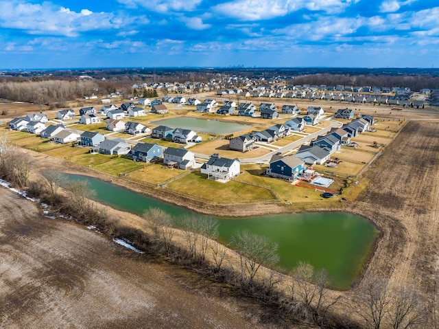 drone / aerial view featuring a residential view and a water view