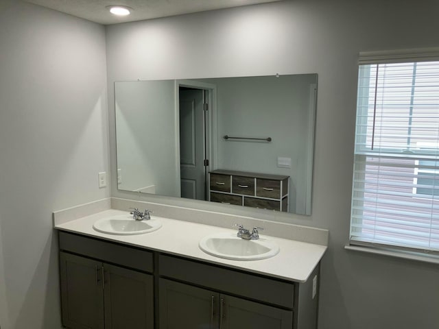 full bath with a sink and double vanity