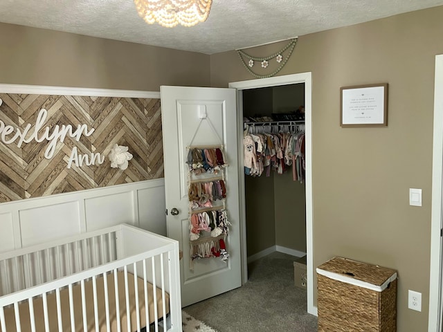 carpeted bedroom with a closet and a textured ceiling