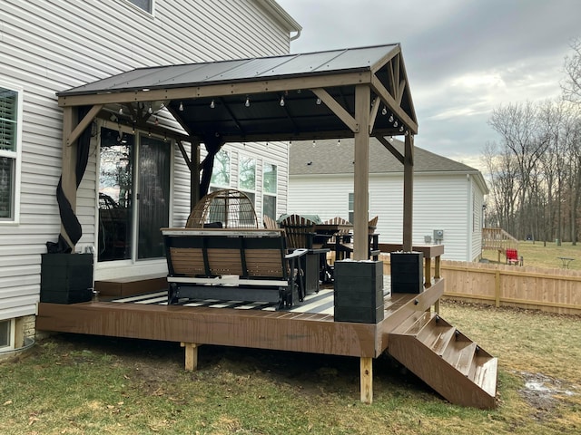 wooden deck featuring fence and a gazebo