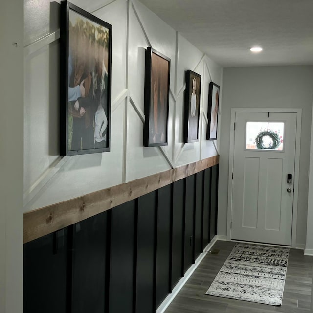 foyer with dark wood-type flooring and recessed lighting