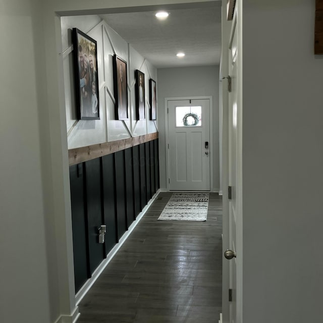 doorway with baseboards, dark wood finished floors, and recessed lighting