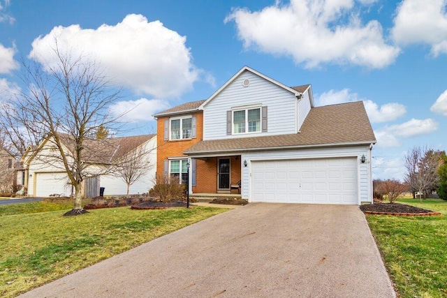 traditional-style house with driveway, brick siding, an attached garage, and a front yard