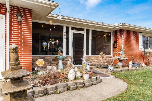 property entrance with brick siding