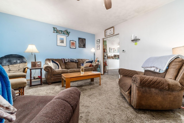 carpeted living area featuring a ceiling fan