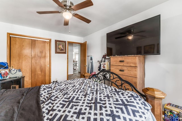 carpeted bedroom with a ceiling fan and a closet