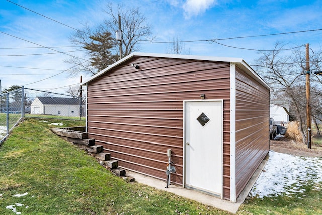 view of outdoor structure featuring an outbuilding and fence