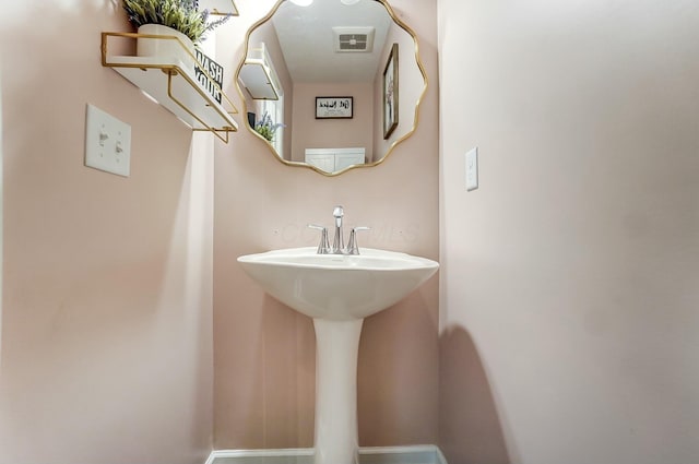 bathroom with visible vents and a sink