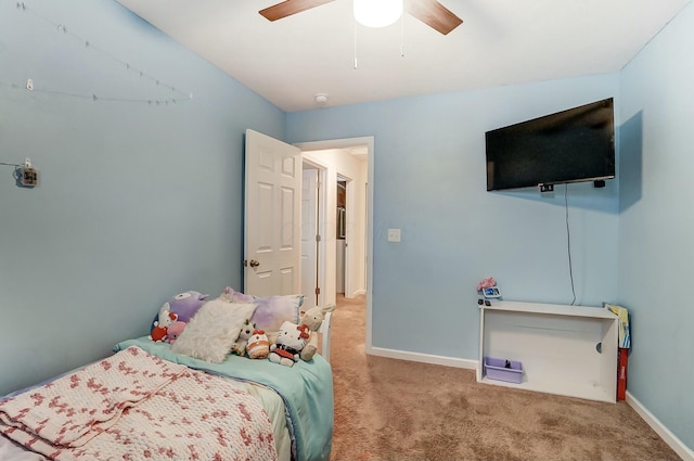 carpeted bedroom with baseboards and a ceiling fan