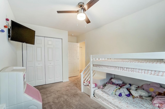 bedroom featuring light carpet, ceiling fan, and a closet