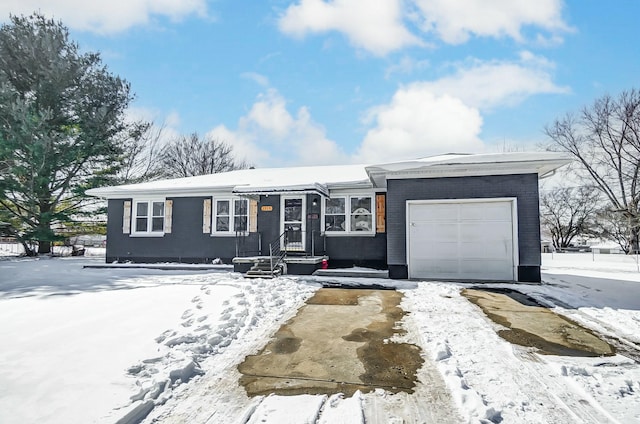 single story home featuring a garage and brick siding