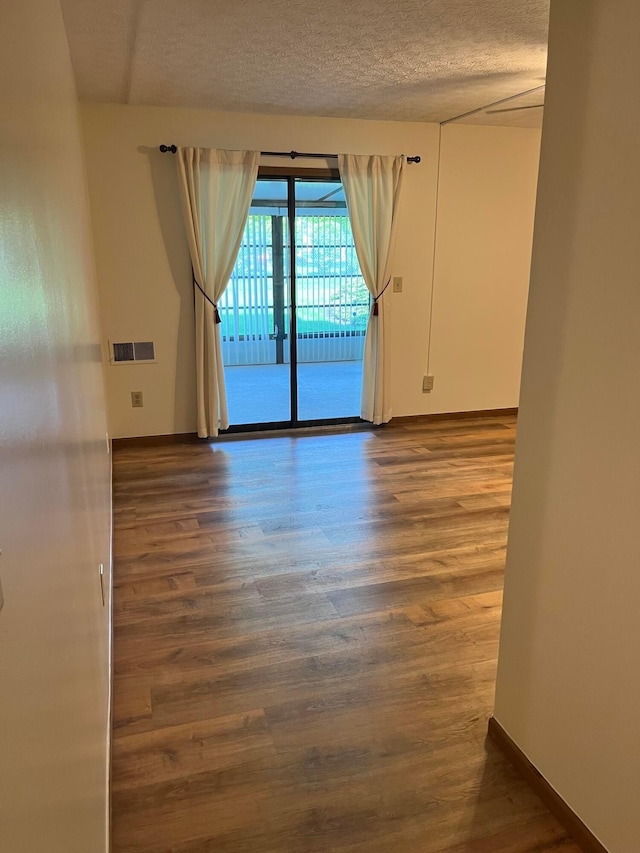 5885 Beechcroft Rd Unit 110, Columbus, OH 43229 - empty room featuring wood finished floors and a textured ceiling