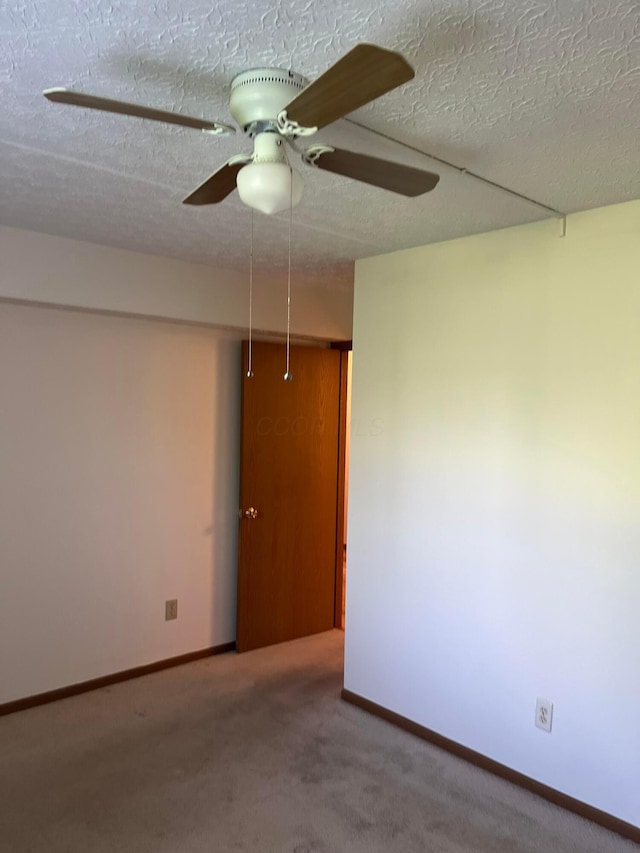 5885 Beechcroft Rd Unit 110, Columbus, OH 43229 - carpeted empty room with a ceiling fan, a textured ceiling, and baseboards