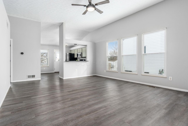 unfurnished living room with lofted ceiling, a ceiling fan, baseboards, and dark wood-type flooring