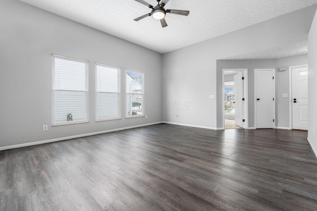 unfurnished room with dark wood-style floors, ceiling fan, baseboards, and a textured ceiling