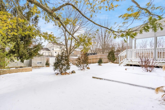 yard covered in snow featuring fence