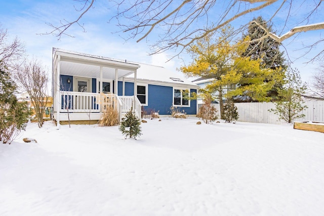 view of front of house with fence and a porch